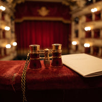 Jumelles de théâtre Scène rouges sur l'accoudoir d'un balcon de théâtre